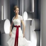 A wedding dress with a red belt is a bright accent for any bride