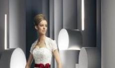 A wedding dress with a red belt is a bright accent for any bride